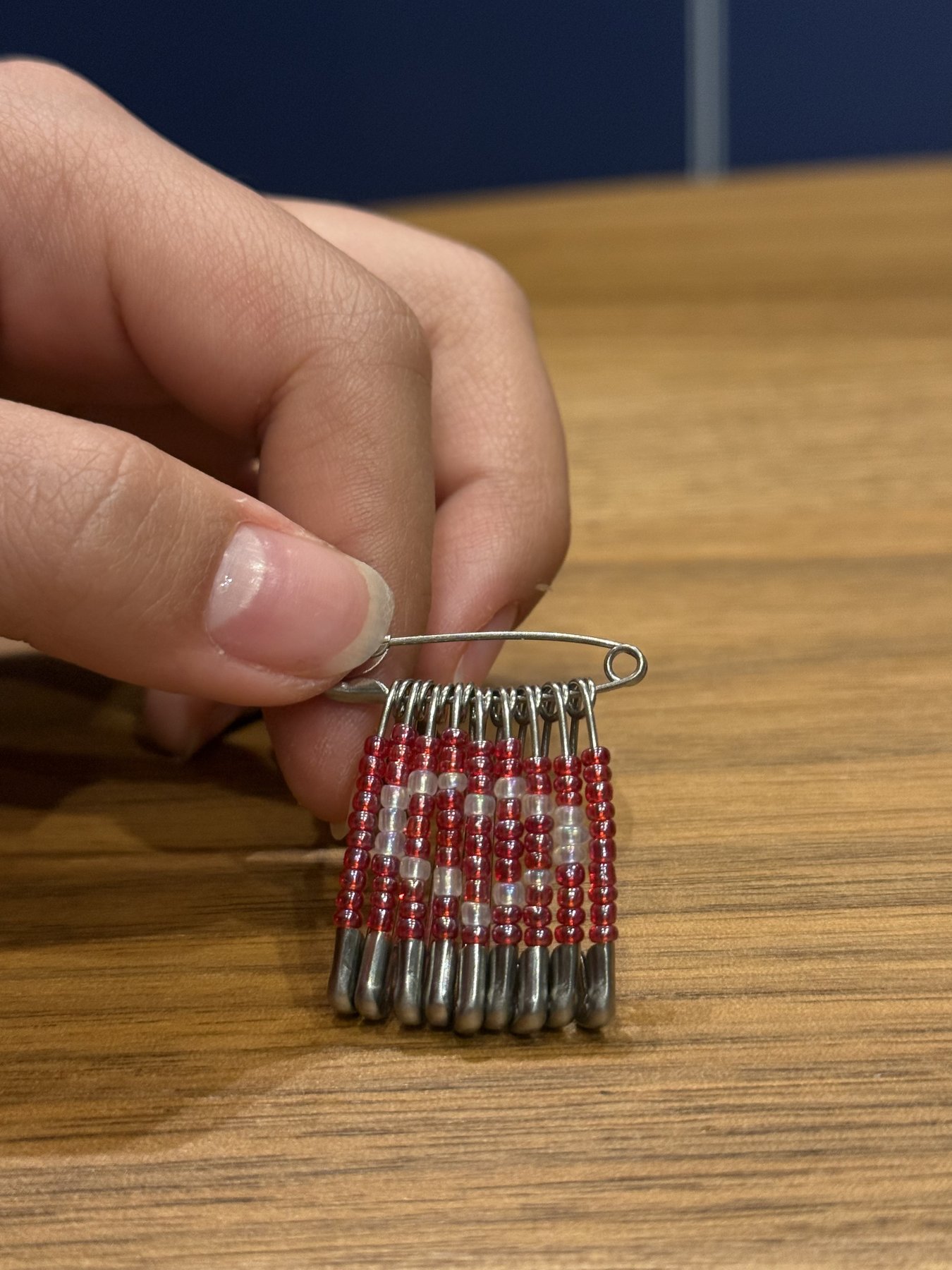 Red and silver beaded safety pin brooch